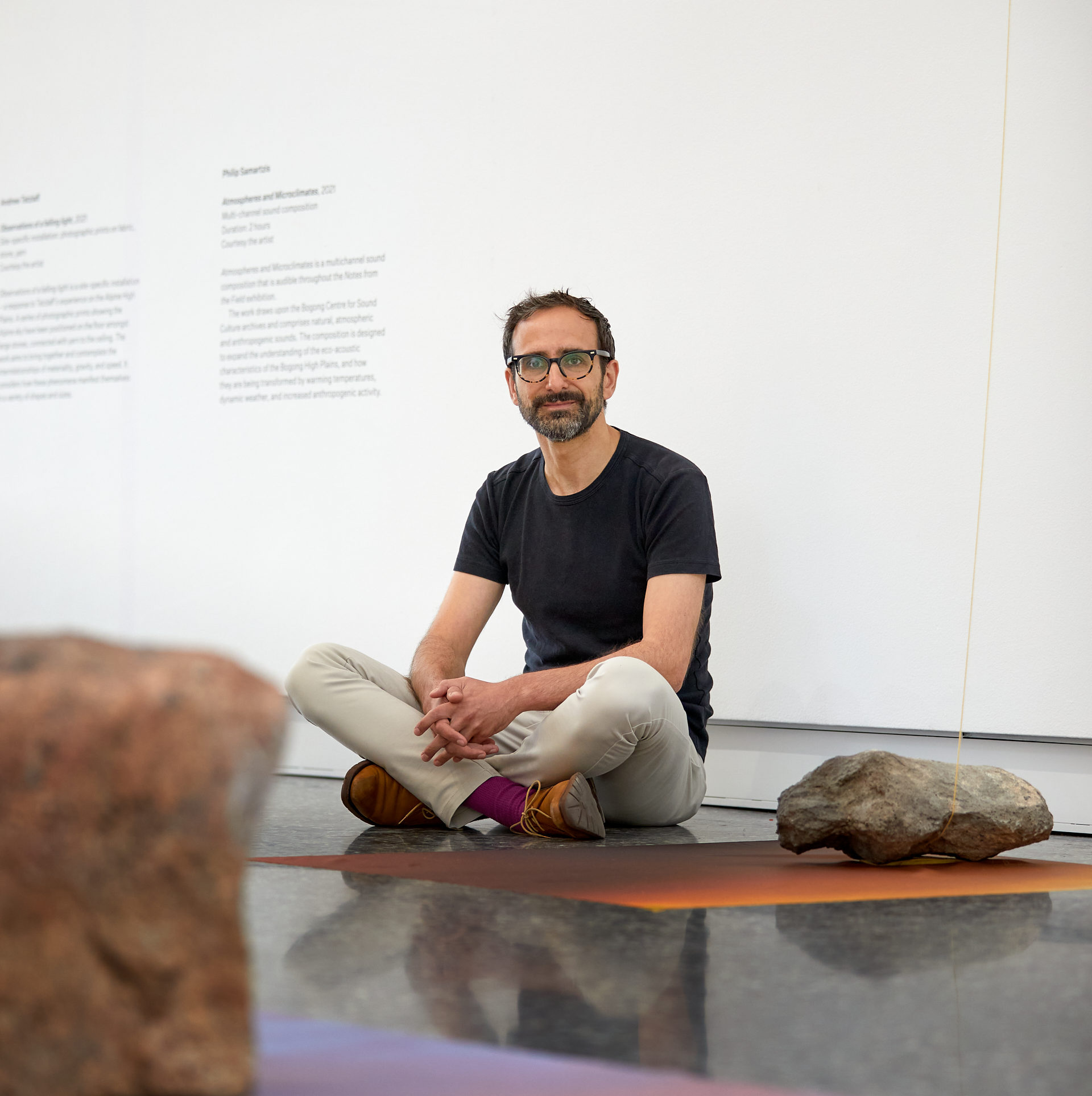 Andrew Tetzlaff portrait sitting in exhibition installation